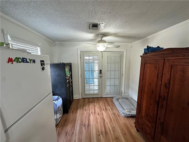 9025 Camille Ct, River Ridge, LA 70123 - doorway to outside with a wealth of natural light, visible vents, wood finished floors, and ornamental molding