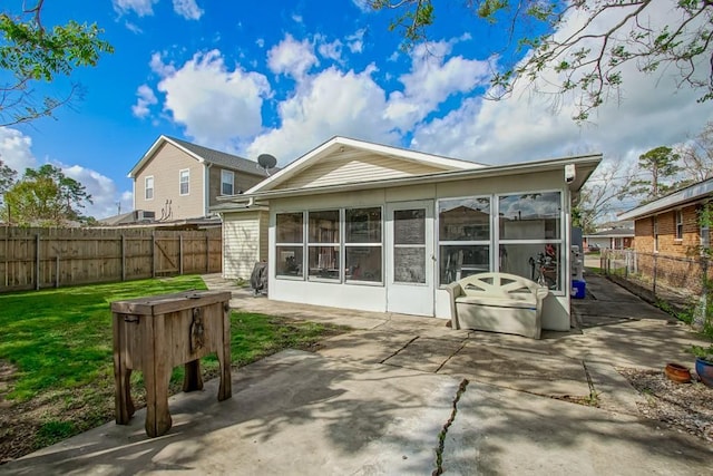 9025 Camille Ct, River Ridge, LA 70123 - back of property with a fenced backyard, a sunroom, a yard, and a patio area