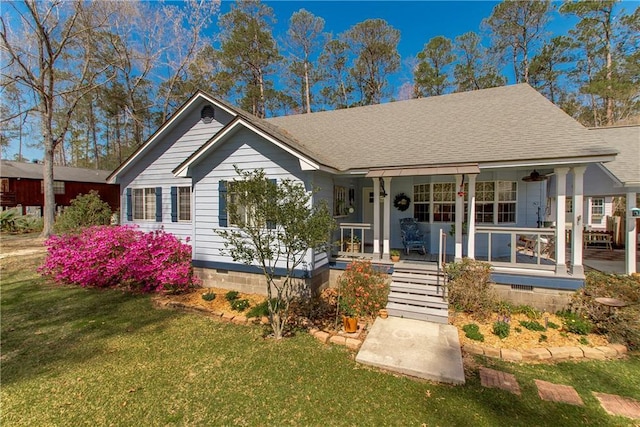 31519 River Pines Dr, Springfield, LA 70462 - view of front of house featuring crawl space, roof with shingles, covered porch, and a front lawn