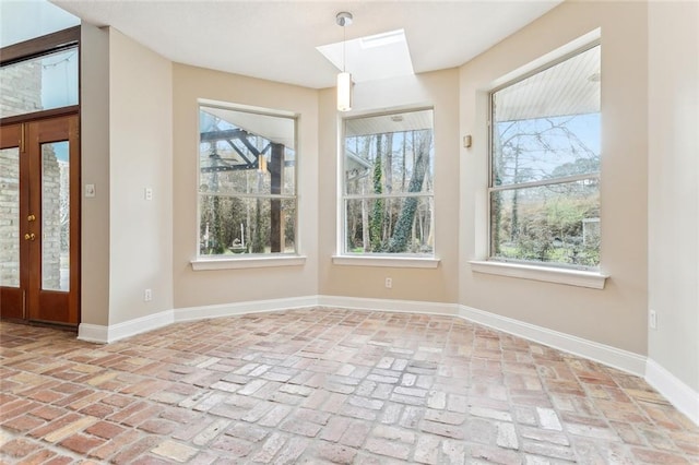 30310 Saint John Dr, Lacombe, LA 70445 - unfurnished dining area featuring baseboards, brick flooring, and a skylight