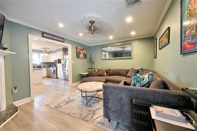1901 N Turnbull Dr, Metairie, LA 70001 - living area featuring ceiling fan, ornamental molding, recessed lighting, and light wood finished floors