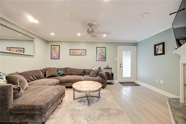 1901 N Turnbull Dr, Metairie, LA 70001 - living room featuring a ceiling fan, recessed lighting, wood finished floors, a fireplace with raised hearth, and ornamental molding