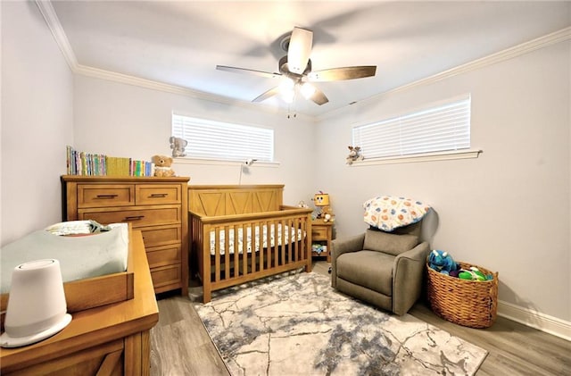 1901 N Turnbull Dr, Metairie, LA 70001 - bedroom with light wood finished floors, a crib, ornamental molding, and ceiling fan