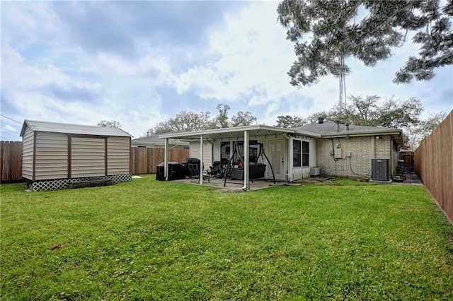1901 N Turnbull Dr, Metairie, LA 70001 - back of property featuring a fenced backyard, a patio area, and a storage unit