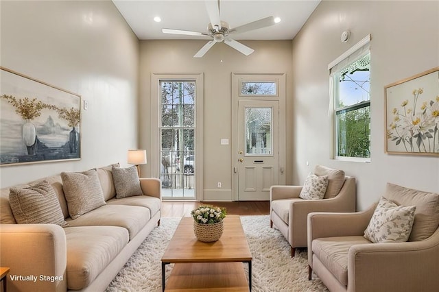living area with a healthy amount of sunlight, a ceiling fan, recessed lighting, and wood finished floors