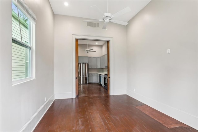interior space featuring recessed lighting, baseboards, dark wood finished floors, and visible vents