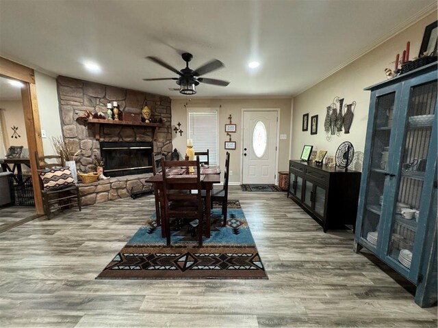 7241 Line Rd, Ethel, LA 70730 - dining room featuring a fireplace, wood finished floors, ceiling fan, and ornamental molding