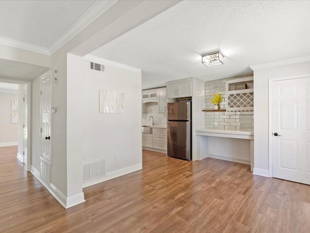 1840 Carol Sue Ave, Terrytown, LA 70056 - kitchen with visible vents, light wood-style floors, light countertops, and freestanding refrigerator
