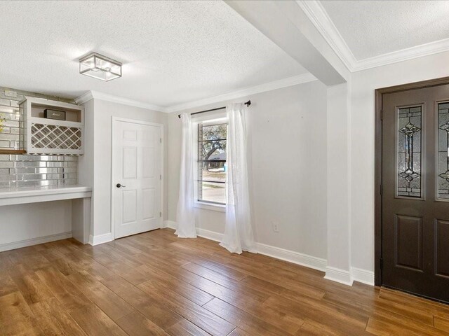 1840 Carol Sue Ave, Terrytown, LA 70056 - unfurnished dining area featuring a textured ceiling, crown molding, baseboards, and wood finished floors