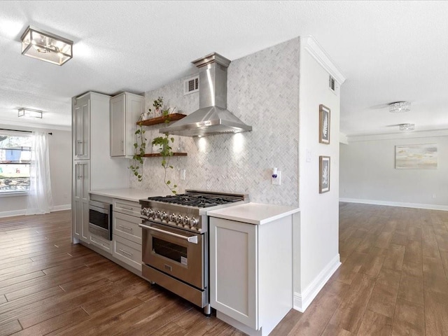 1840 Carol Sue Ave, Terrytown, LA 70056 - kitchen featuring open shelves, wood finished floors, stainless steel appliances, wall chimney exhaust hood, and decorative backsplash