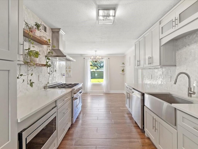 1840 Carol Sue Ave, Terrytown, LA 70056 - kitchen featuring open shelves, a sink, dark wood-type flooring, appliances with stainless steel finishes, and wall chimney range hood
