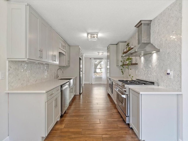 1840 Carol Sue Ave, Terrytown, LA 70056 - kitchen with a sink, wall chimney range hood, wood finished floors, appliances with stainless steel finishes, and light countertops