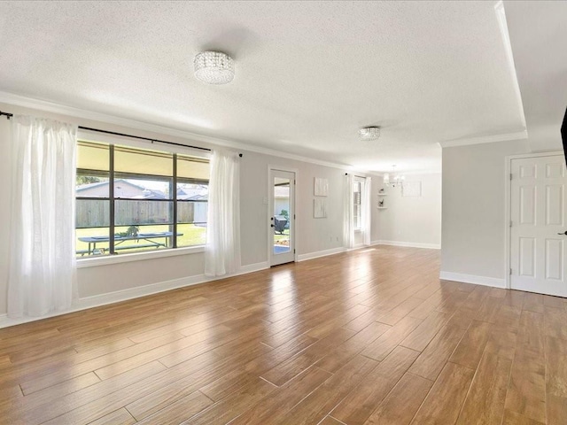 1840 Carol Sue Ave, Terrytown, LA 70056 - interior space with a textured ceiling, an inviting chandelier, wood finished floors, and ornamental molding