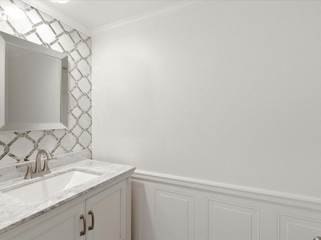 1840 Carol Sue Ave, Terrytown, LA 70056 - bathroom featuring ornamental molding, decorative backsplash, wainscoting, a decorative wall, and vanity