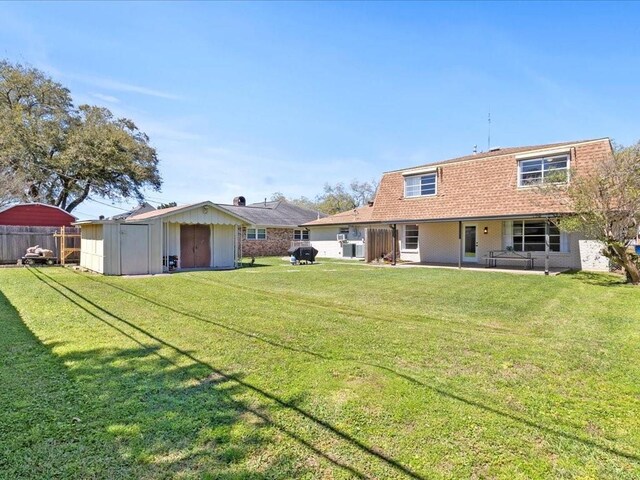 1840 Carol Sue Ave, Terrytown, LA 70056 - rear view of house featuring an outbuilding, fence, a shed, a lawn, and brick siding