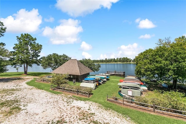 view of dock featuring a water view and fence