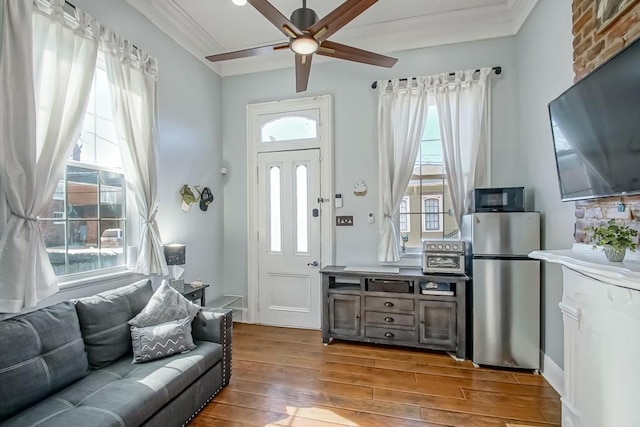 326 N Tonti St, New Orleans, LA 70119 - living room featuring wood finished floors, a ceiling fan, and ornamental molding