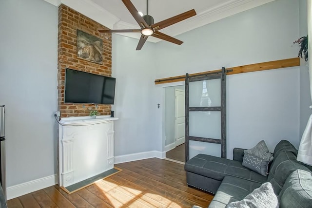 326 N Tonti St, New Orleans, LA 70119 - living area with a barn door, hardwood / wood-style floors, ornamental molding, and ceiling fan