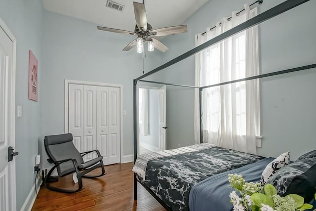 326 N Tonti St, New Orleans, LA 70119 - bedroom with hardwood / wood-style flooring, a closet, multiple windows, and a ceiling fan
