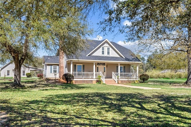 farmhouse inspired home with covered porch and a front yard