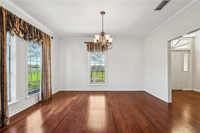unfurnished room with a wealth of natural light, an inviting chandelier, and wood-type flooring