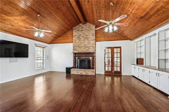 unfurnished living room with lofted ceiling with beams, wood finished floors, wooden ceiling, a fireplace, and ceiling fan