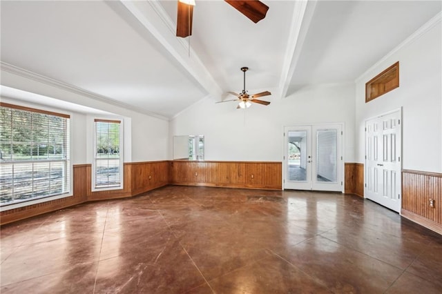 unfurnished room with lofted ceiling with beams, a wainscoted wall, a ceiling fan, and crown molding