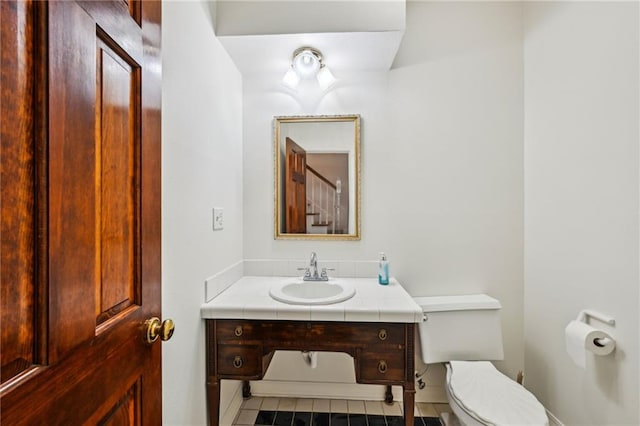 bathroom featuring toilet and vanity
