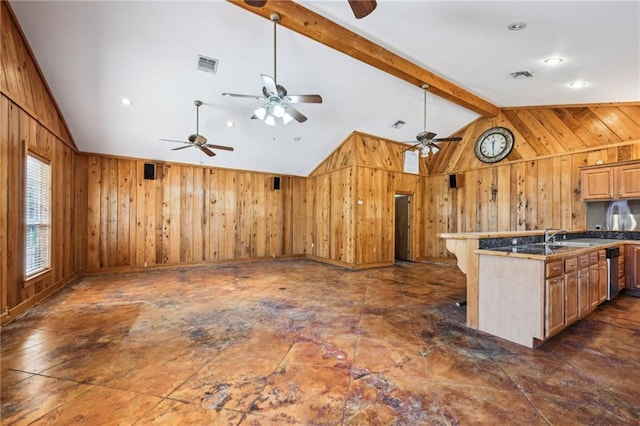 kitchen with visible vents, wood walls, beamed ceiling, and ceiling fan