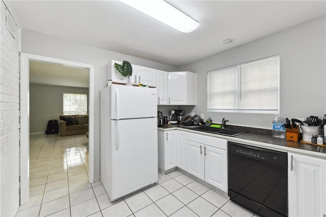 372931 Lilac Ln, Metairie, LA 70001 - kitchen with dishwasher, a sink, freestanding refrigerator, white cabinetry, and light tile patterned flooring