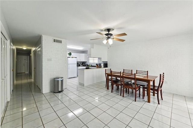 372931 Lilac Ln, Metairie, LA 70001 - dining area featuring visible vents, ceiling fan, light tile patterned flooring, and brick wall