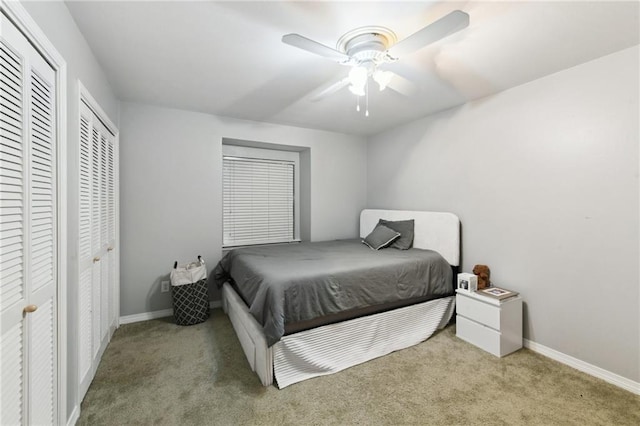 372931 Lilac Ln, Metairie, LA 70001 - bedroom featuring carpet, baseboards, two closets, and ceiling fan