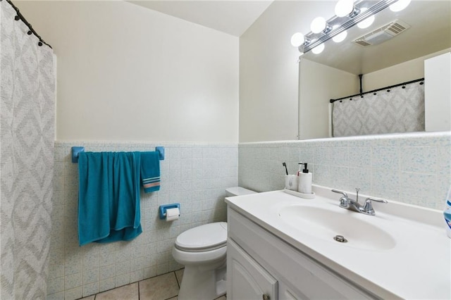 372931 Lilac Ln, Metairie, LA 70001 - bathroom featuring vanity, visible vents, toilet, tile walls, and tile patterned floors