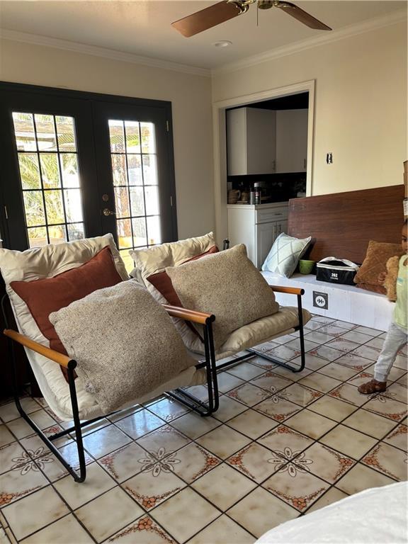 372931 Lilac Ln, Metairie, LA 70001 - living room with french doors, ornamental molding, a ceiling fan, and light tile patterned floors