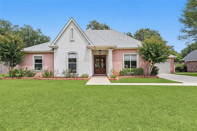 112 Landings Blvd, Slidell, LA 70461 - view of front of property featuring french doors, an attached garage, a front yard, and brick siding