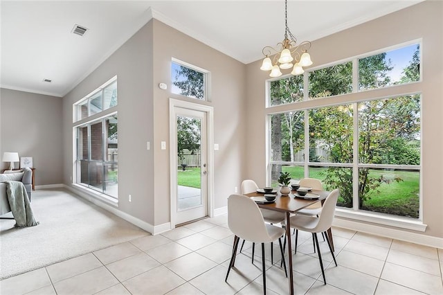 112 Landings Blvd, Slidell, LA 70461 - dining space with crown molding, a chandelier, baseboards, and light tile patterned floors