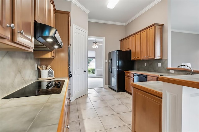 112 Landings Blvd, Slidell, LA 70461 - kitchen featuring range hood, black appliances, tasteful backsplash, crown molding, and tile countertops