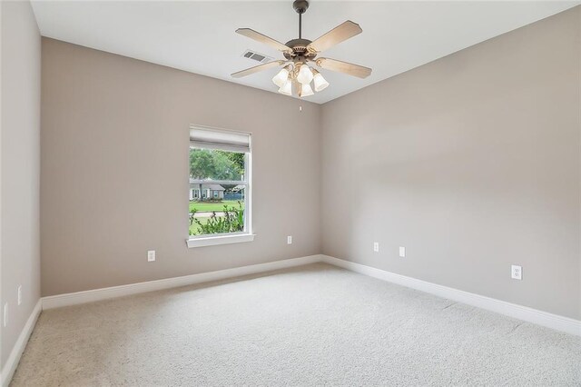 112 Landings Blvd, Slidell, LA 70461 - spare room featuring baseboards, light carpet, and a ceiling fan