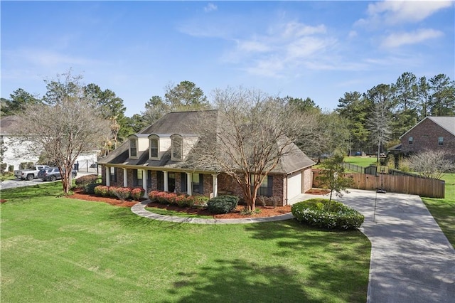 cape cod home with brick siding, fence, concrete driveway, a front yard, and a garage