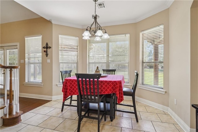dining area with visible vents, baseboards, a notable chandelier, and ornamental molding