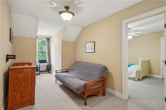 sitting room featuring vaulted ceiling, carpet flooring, and baseboards