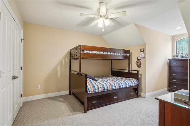 bedroom with vaulted ceiling, carpet flooring, and baseboards