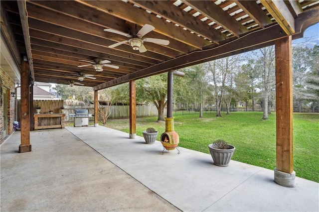 view of patio / terrace featuring area for grilling, a fenced backyard, and a ceiling fan