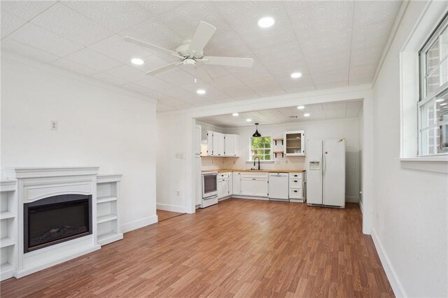 3284 Reine Ave, Slidell, LA 70458 - kitchen featuring white appliances, open shelves, under cabinet range hood, a sink, and dark wood-type flooring