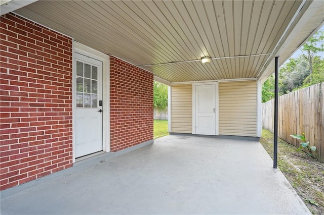 view of patio / terrace featuring a carport and fence