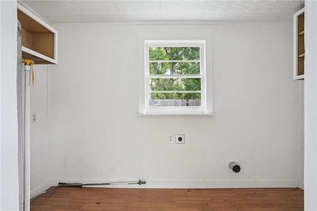clothes washing area featuring hookup for an electric dryer and wood finished floors