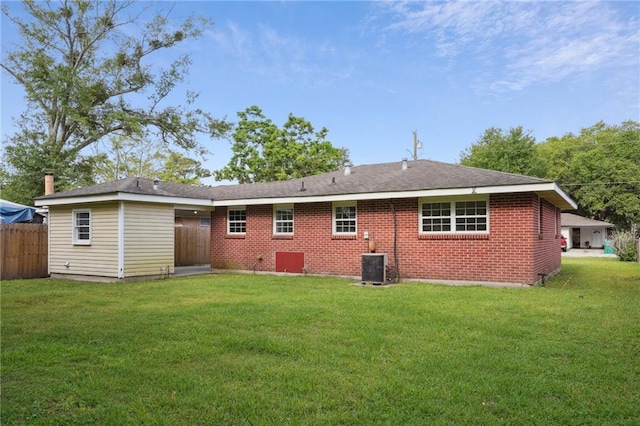 rear view of house featuring brick siding and central AC unit