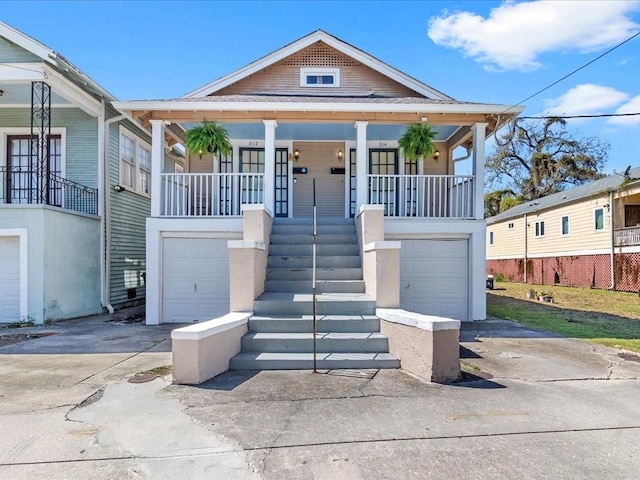 311214 General Taylor St, New Orleans, LA 70125 - view of front facade featuring a garage, concrete driveway, covered porch, and stairs