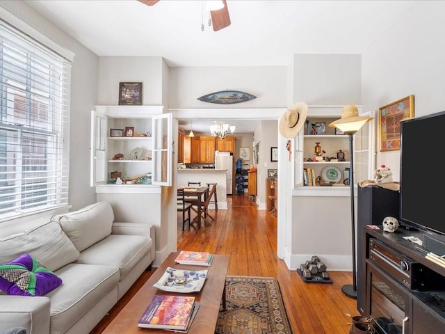 311214 General Taylor St, New Orleans, LA 70125 - living room featuring a chandelier, light wood finished floors, plenty of natural light, and a ceiling fan
