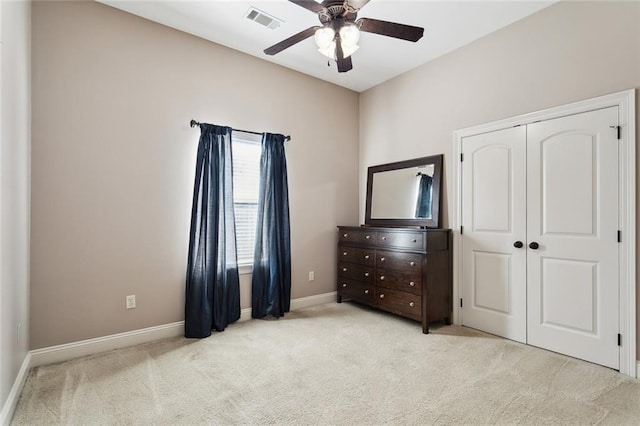 bedroom featuring a closet, carpet flooring, a ceiling fan, baseboards, and visible vents